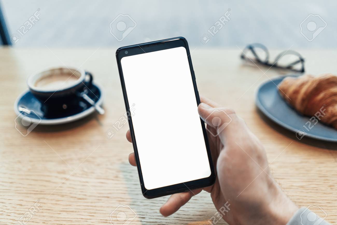 Close up of man tattooed hands holding mobile phone with blank screen. - 114374469 Close up of man tattooed hands holding mobile phone with blank screen. - 114374469