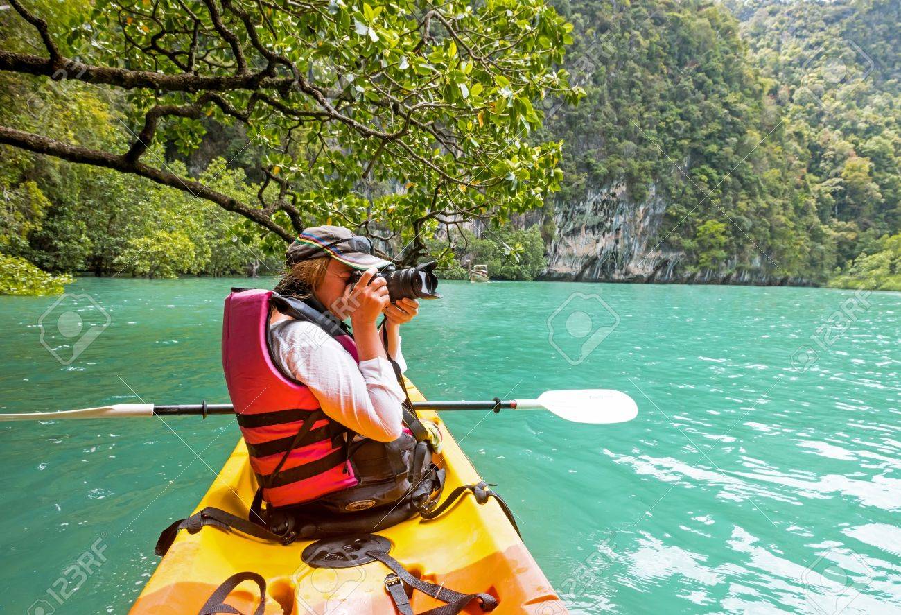 woman on kayak in calm tropical lagoon on koh hong island stock