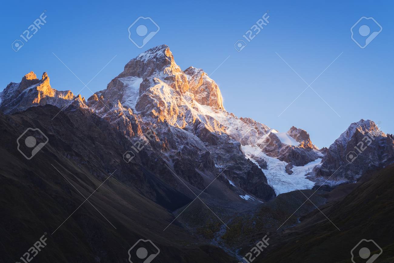 Most beautiful mountain in the Caucasus. Top of Ushba at dawn. Pure morning sky. Beauty in nature. Main Caucasian ridge. Zemo Svaneti, Georgia - 61560852 Most beautiful mountain in the Caucasus. Top of Ushba at dawn. Pure morning sky. Beauty in nature. Main Caucasian ridge. Zemo Svaneti, Georgia - 61560852