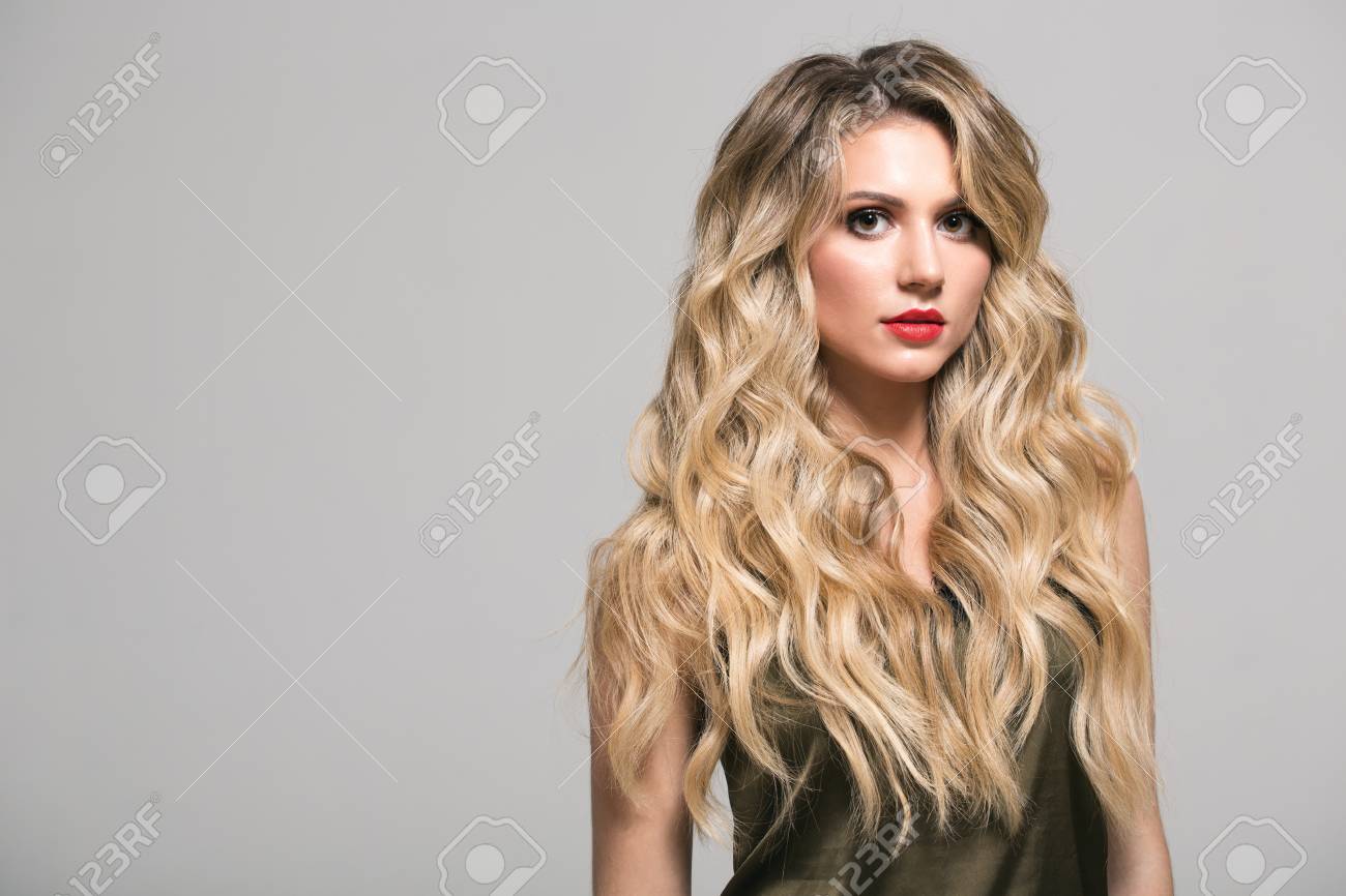 Blonde Girl With Long And Volume Shiny Wavy Hair Beautiful Woman