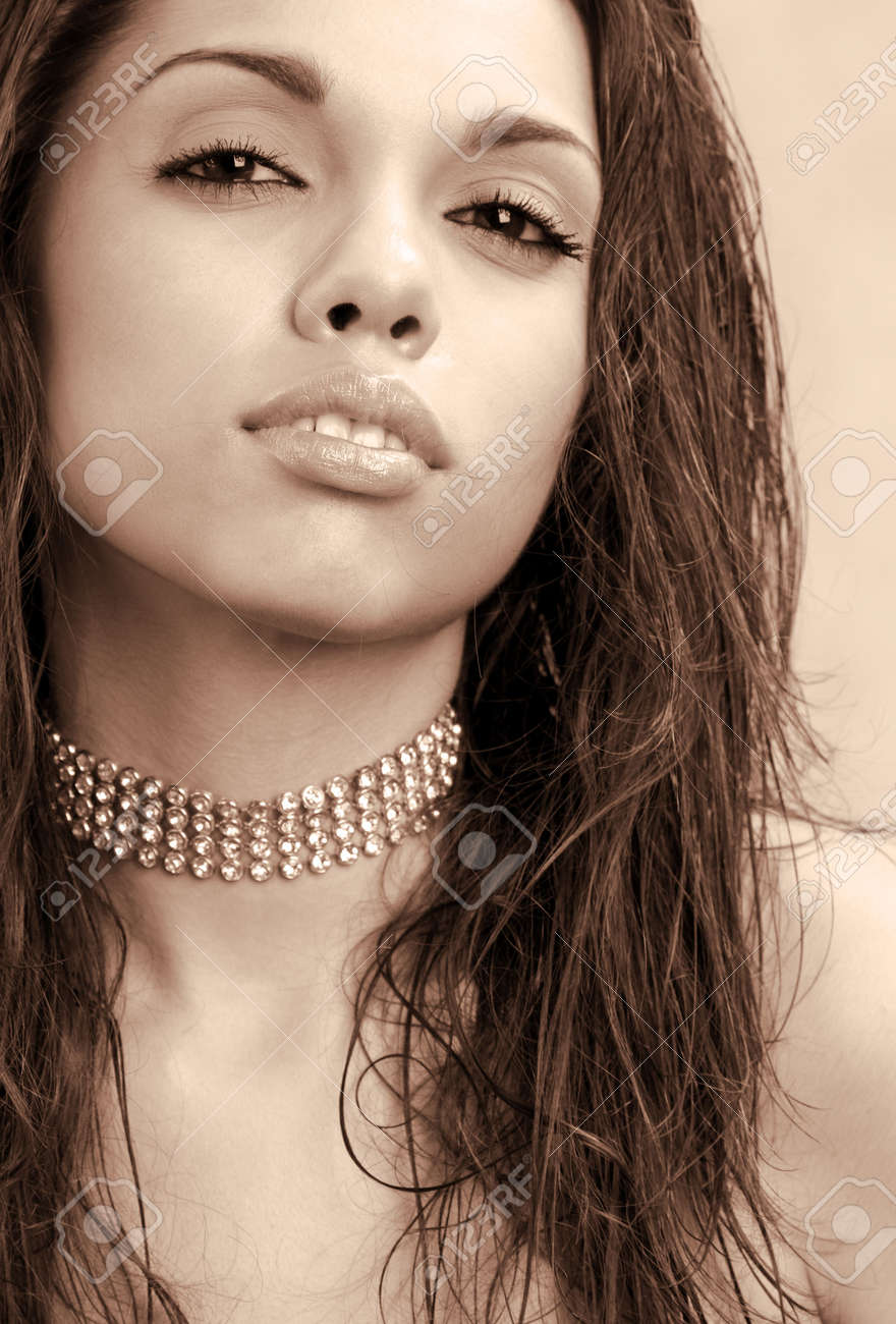 a sepia portrait of a young woman with long stringy hair stock