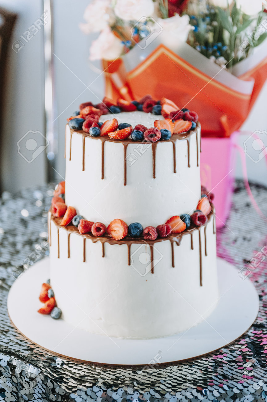Chocolate cake with whipped cream and fresh berries. Close up. Sponge cake with strawberries and vanilla cream. - 168823255 Chocolate cake with whipped cream and fresh berries. Close up. Sponge cake with strawberries and vanilla cream. - 168823255