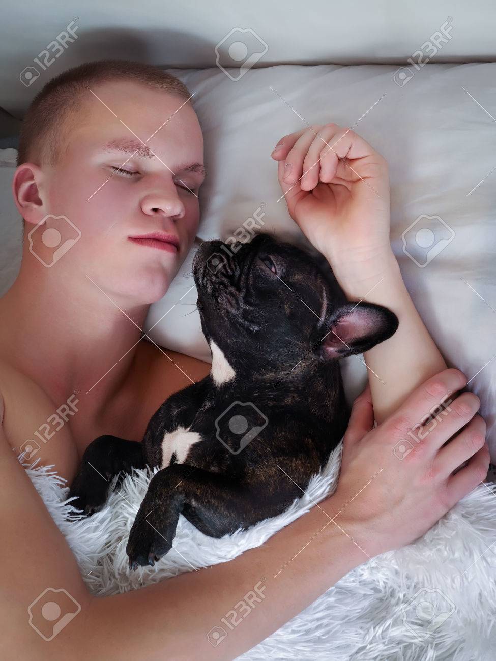 man sleeps with dog