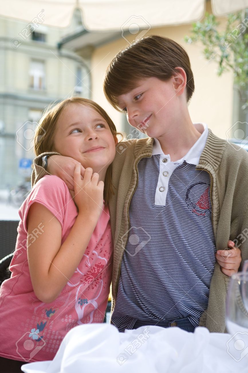 a boy and girl brother and sister share a hug and a tender stock
