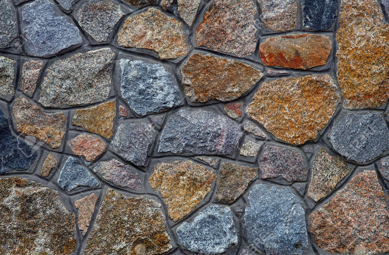 stone wall. wall of granite blocks. a masonry wall of multicolored stones or blocks close up - 169620125 stone wall. wall of granite blocks. a masonry wall of multicolored stones or blocks close up - 169620125