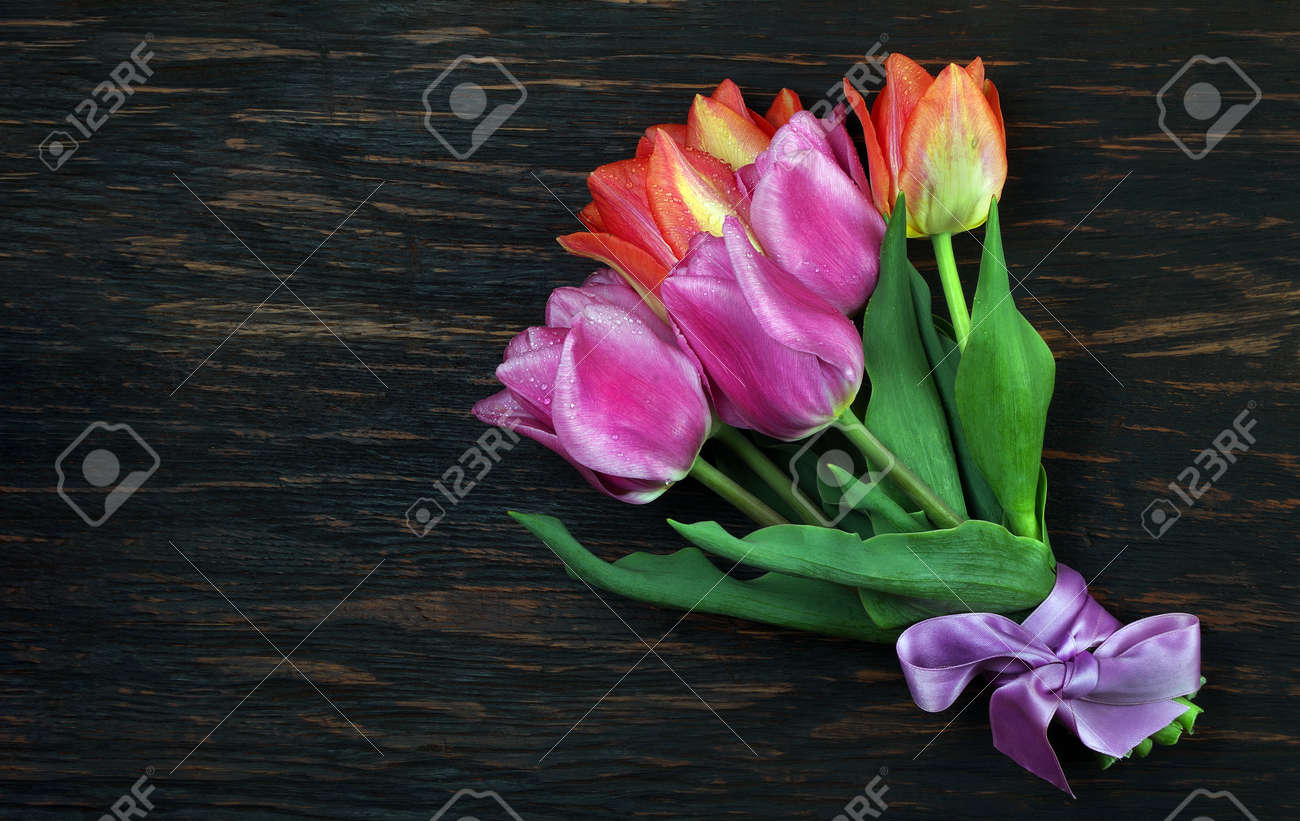 bright colorful bouquet of tulips on a wooden table. - 169620142 bright colorful bouquet of tulips on a wooden table. - 169620142