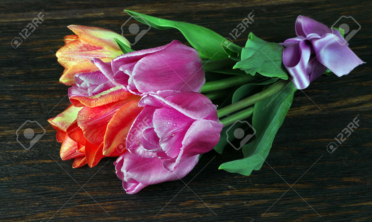 bright colorful bouquet of tulips on a wooden table. - 169620153 bright colorful bouquet of tulips on a wooden table. - 169620153