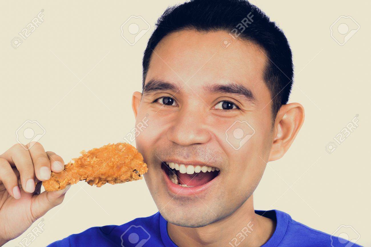 フライド チキンの足 またはバチ ビンテージ トーンを食べようとして若いアジア男 の写真素材 画像素材 Image