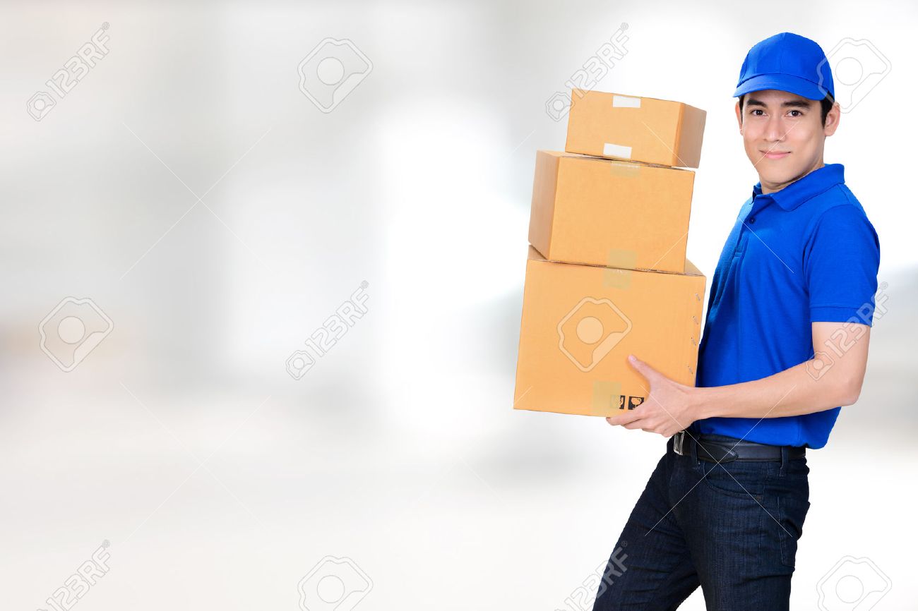 smiling friendly delivery man carrying parcel boxes on blur white
