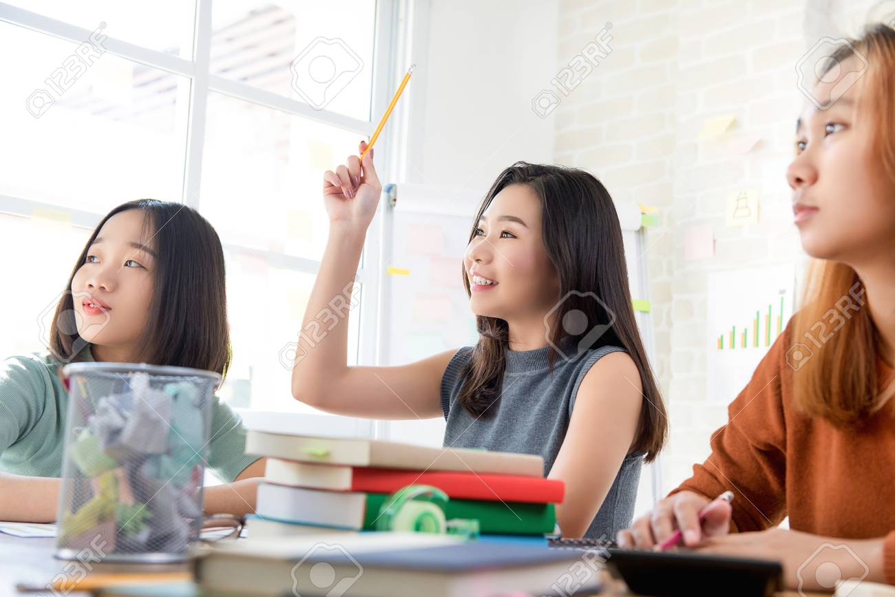 Asian Female Oversea College Student Raising Her Hand Asking Question In  The Classroom While Studying Stock Photo, Picture and Royalty Free Image.  Image 93275618., image size:1300x867