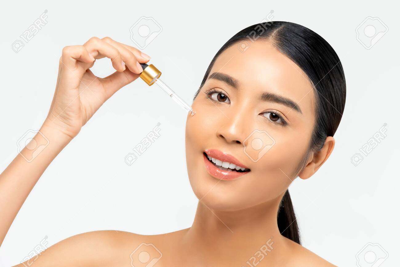applying serum on face