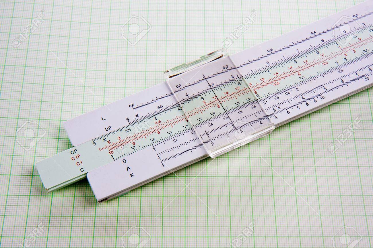 old used slide rule on squared paper stock photo picture and