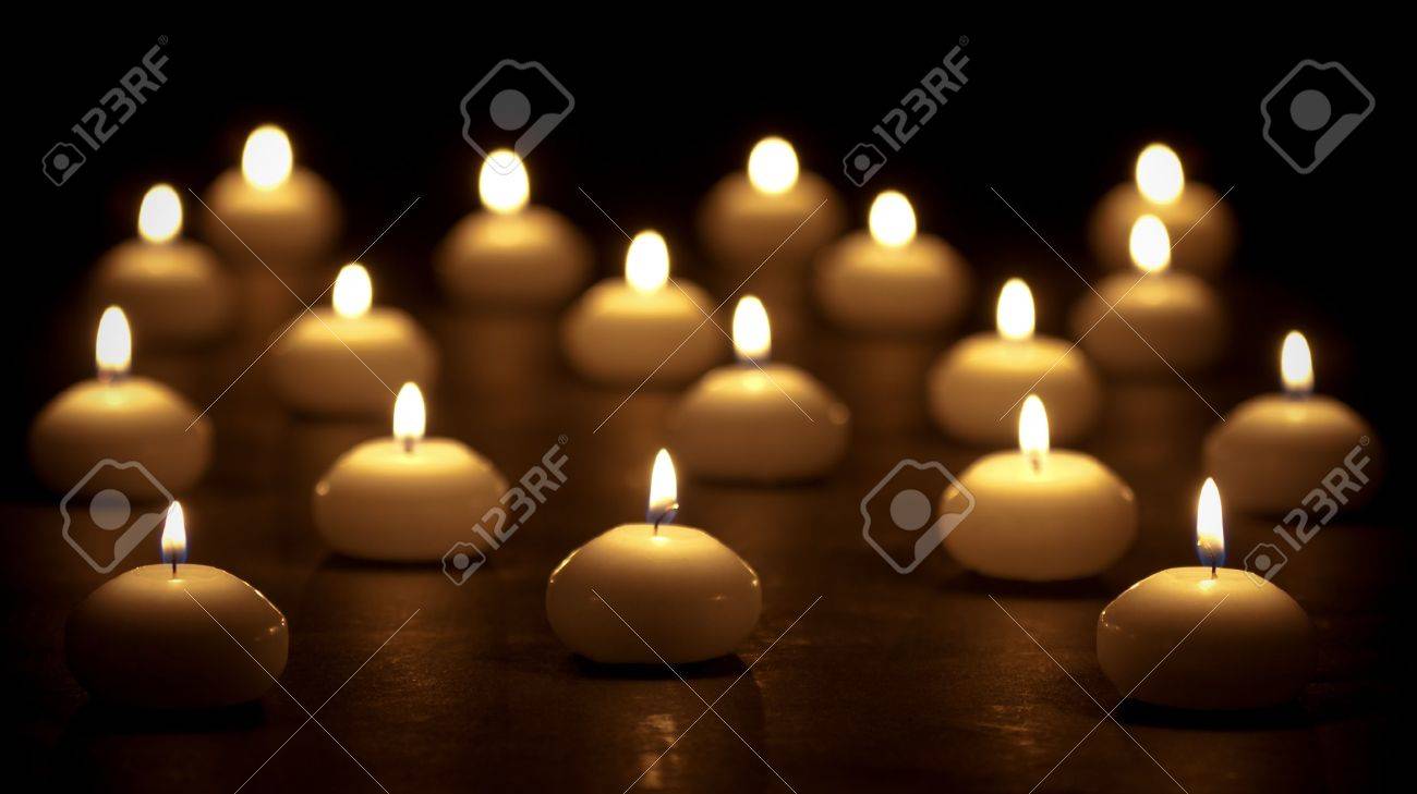 Group of burning candles at a black background with selective focus - 11156597 Group of burning candles at a black background with selective focus - 11156597