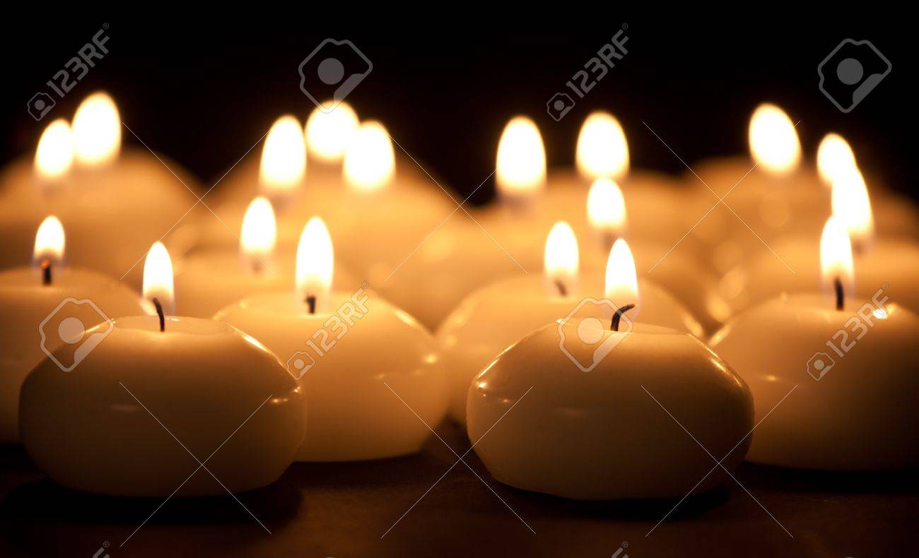 Group of burning candles at a black background with selective focus - 11156600 Group of burning candles at a black background with selective focus - 11156600