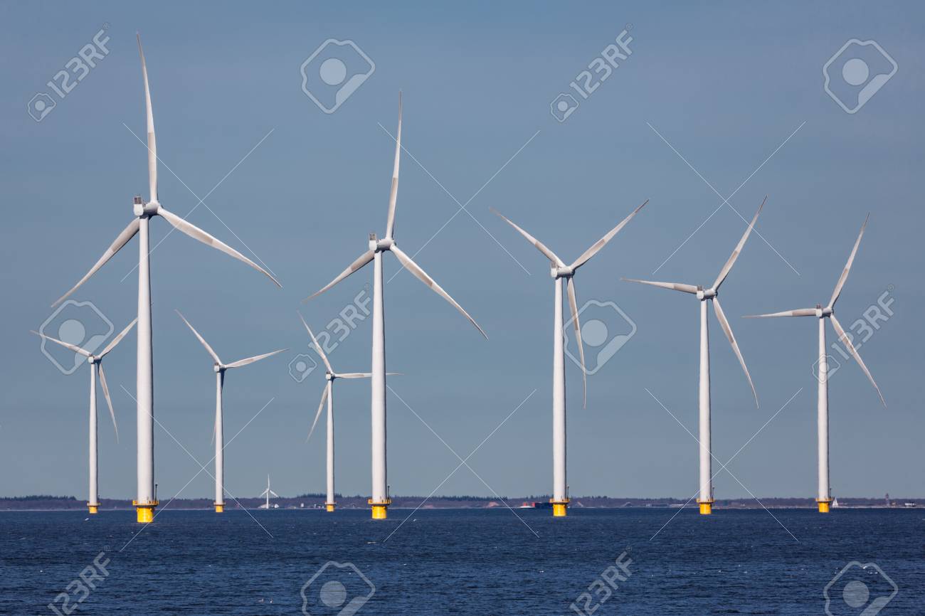 Offshore farm windturbines near Dutch coast against blue sky - 75805690 Offshore farm windturbines near Dutch coast against blue sky - 75805690