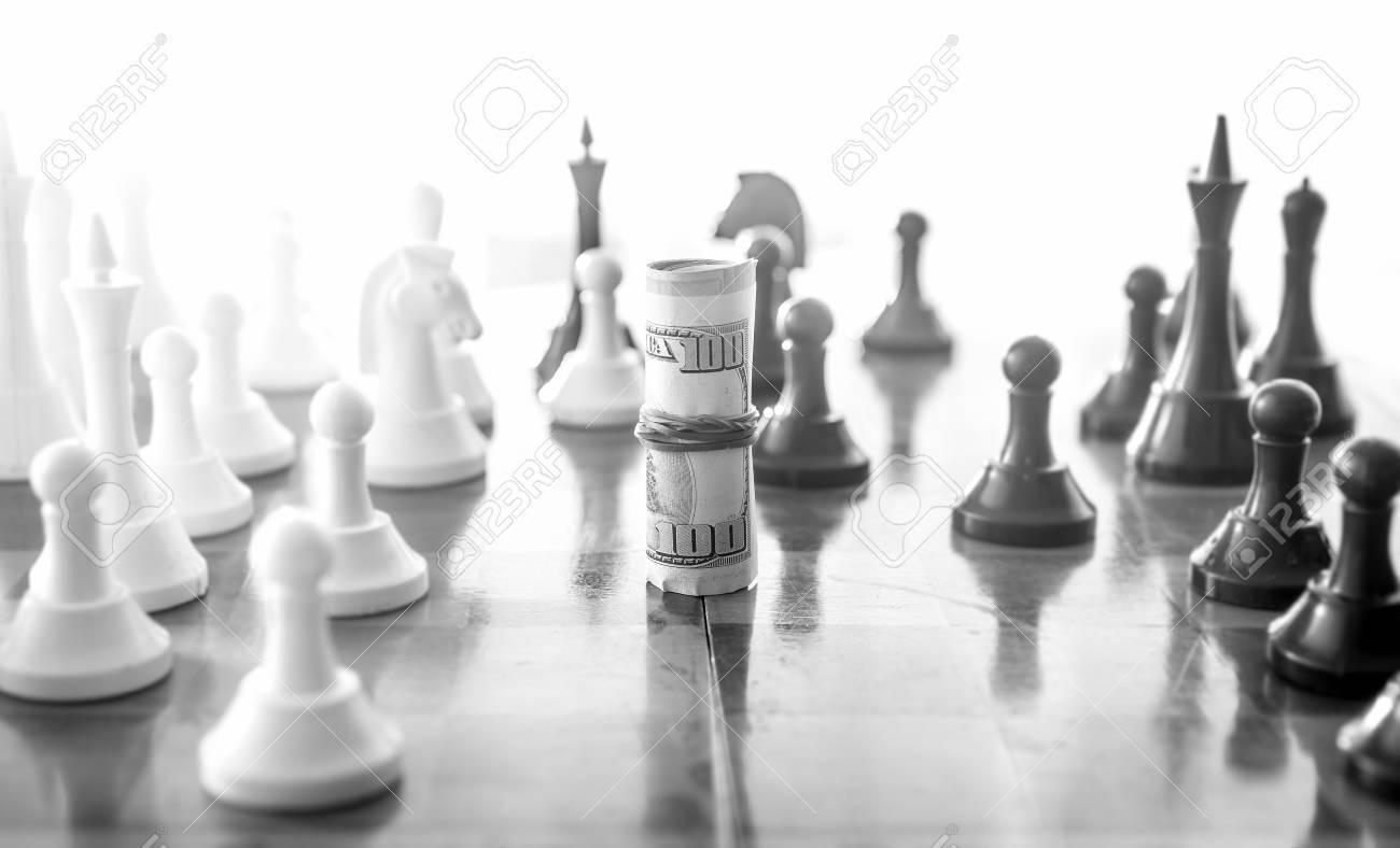Black and white conceptual photo of wrapped money playing in chess as chess piece - 41475311 Black and white conceptual photo of wrapped money playing in chess as chess piece - 41475311