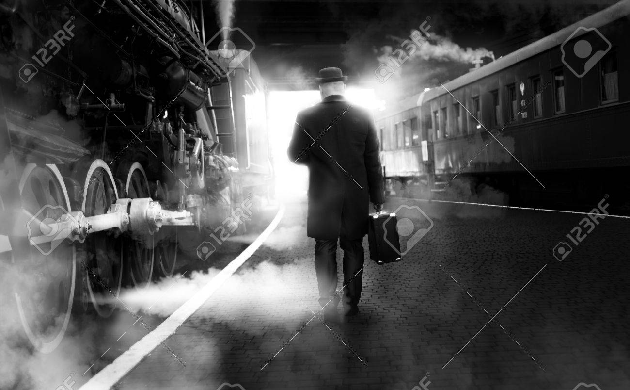 Black and white photo of man in vintage clothes walking on old railway station - 51875002 Black and white photo of man in vintage clothes walking on old railway station - 51875002