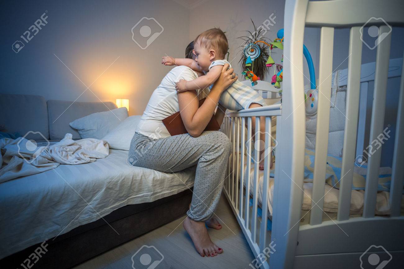 Cute baby boy got scared at night at hugging young caring mother - 62245248 Cute baby boy got scared at night at hugging young caring mother - 62245248