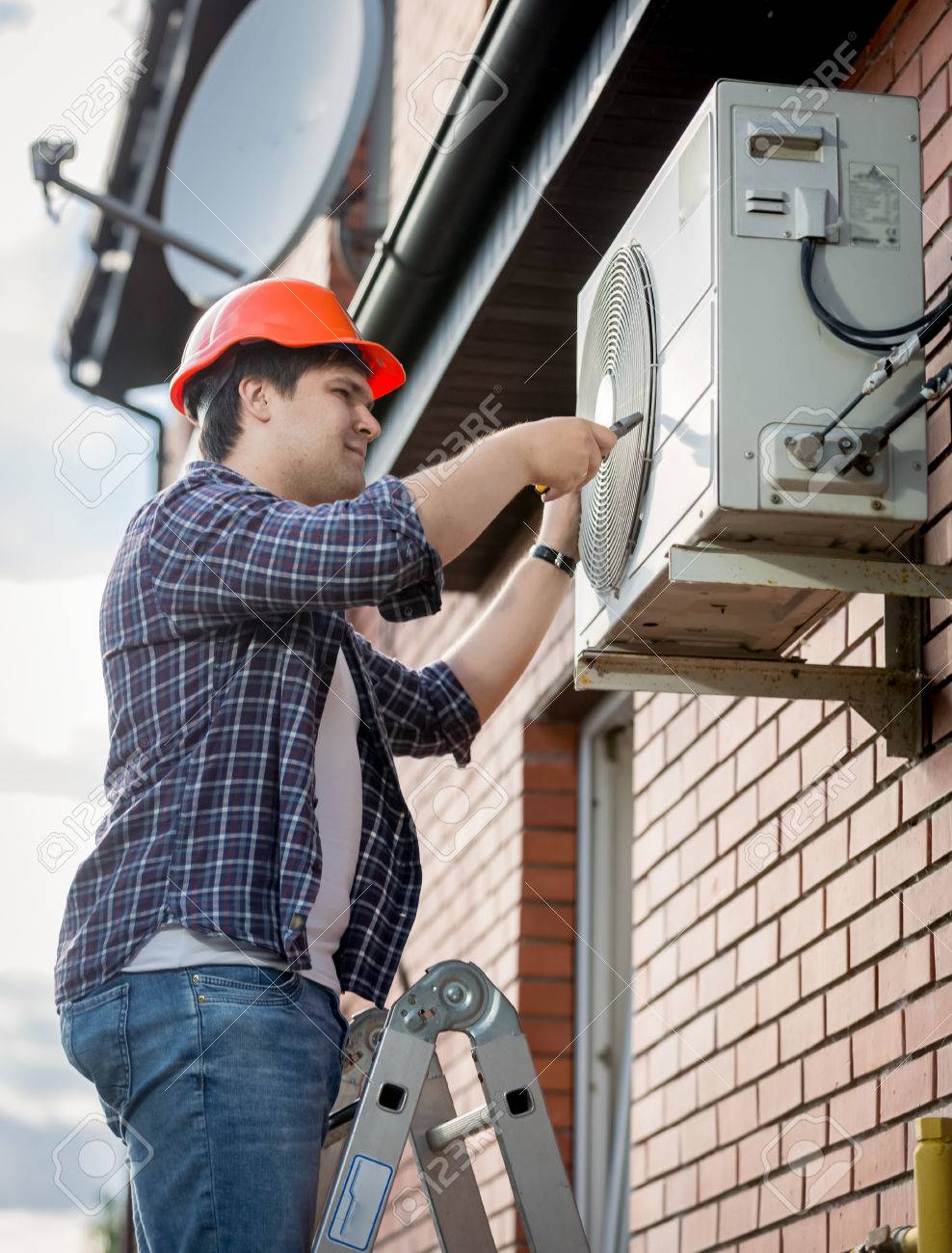 Young male technician repairing outdoor air conditioning system - 62493845 Young male technician repairing outdoor air conditioning system - 62493845