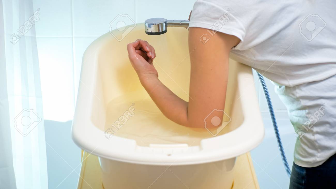 Closeup Photo Of Young Woman Checking Water Temperature In Baby Stock Photo Picture And Royalty Free Image Image 100805487