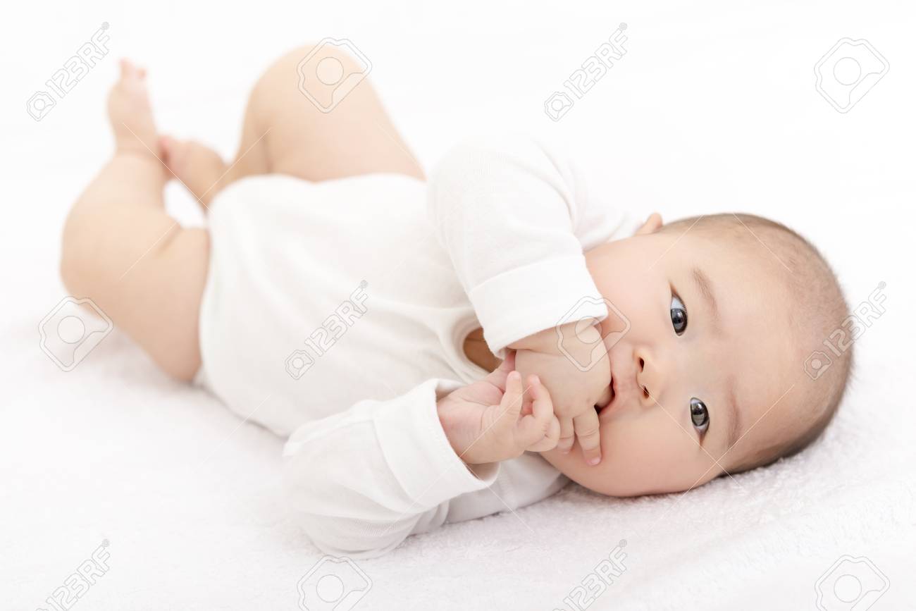 Rolling over baby on the bed - 93698287 Rolling over baby on the bed - 93698287