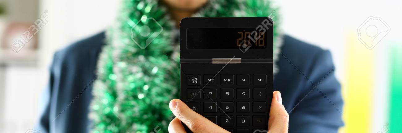 man in suit hold in arm calculator with 2018 year stock photo arm calculator