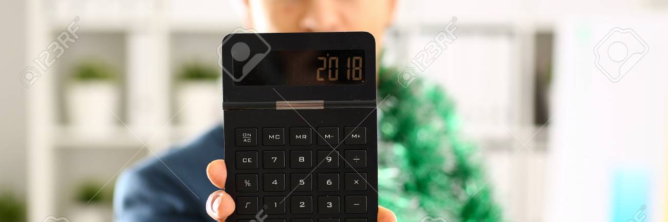 man in suit hold in arm calculator with 2018 year stock photo arm calculator