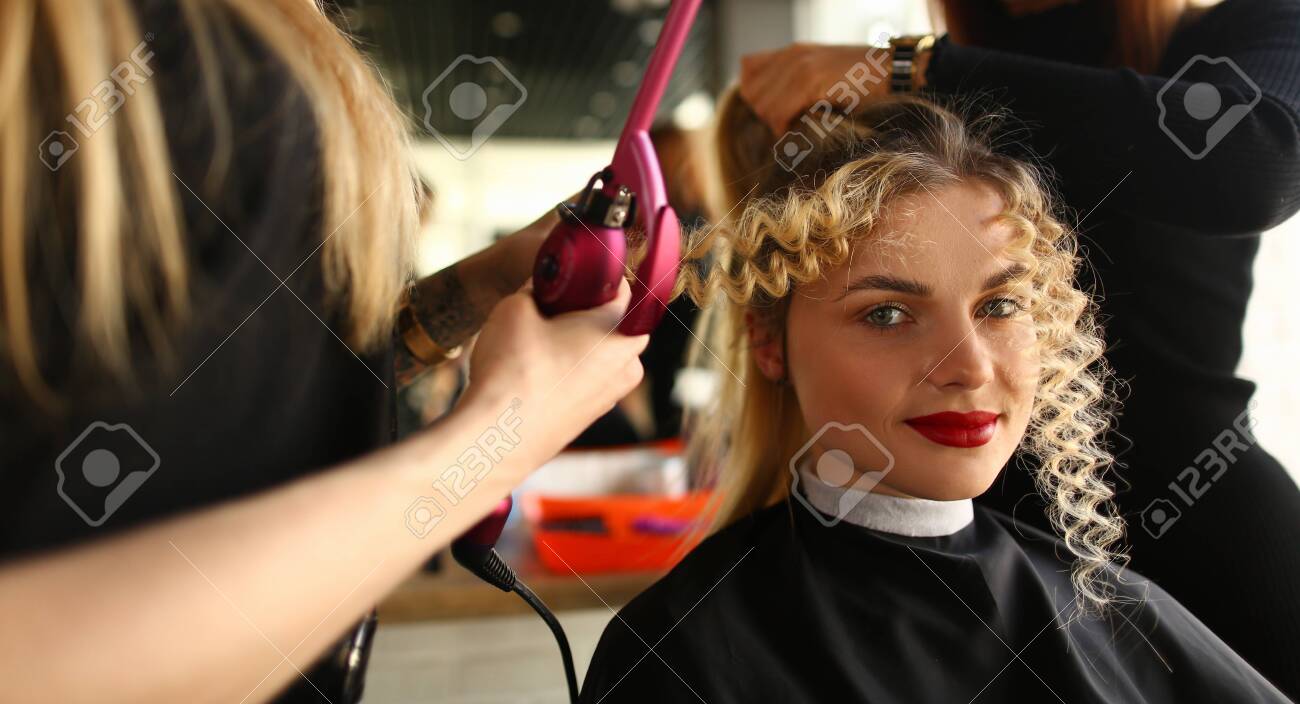 Young Woman Getting Curly Hair By Curling Iron Styling Wavy