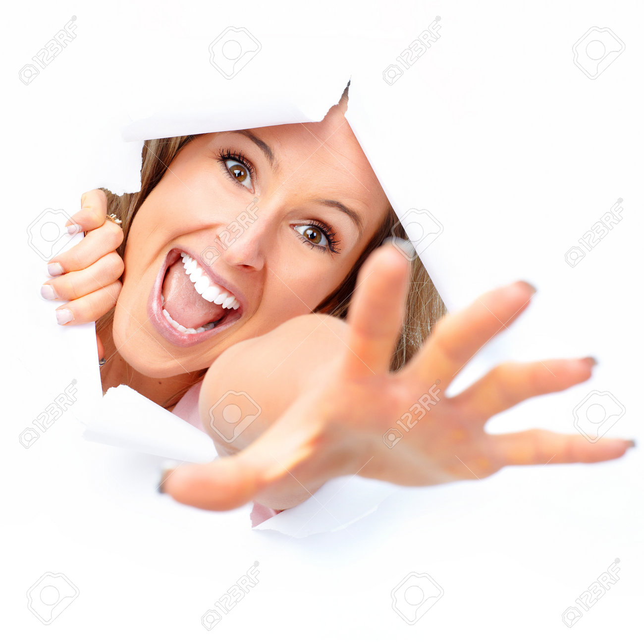 Cute young woman smiling looking through a hole - 8868583 Cute young woman smiling looking through a hole - 8868583