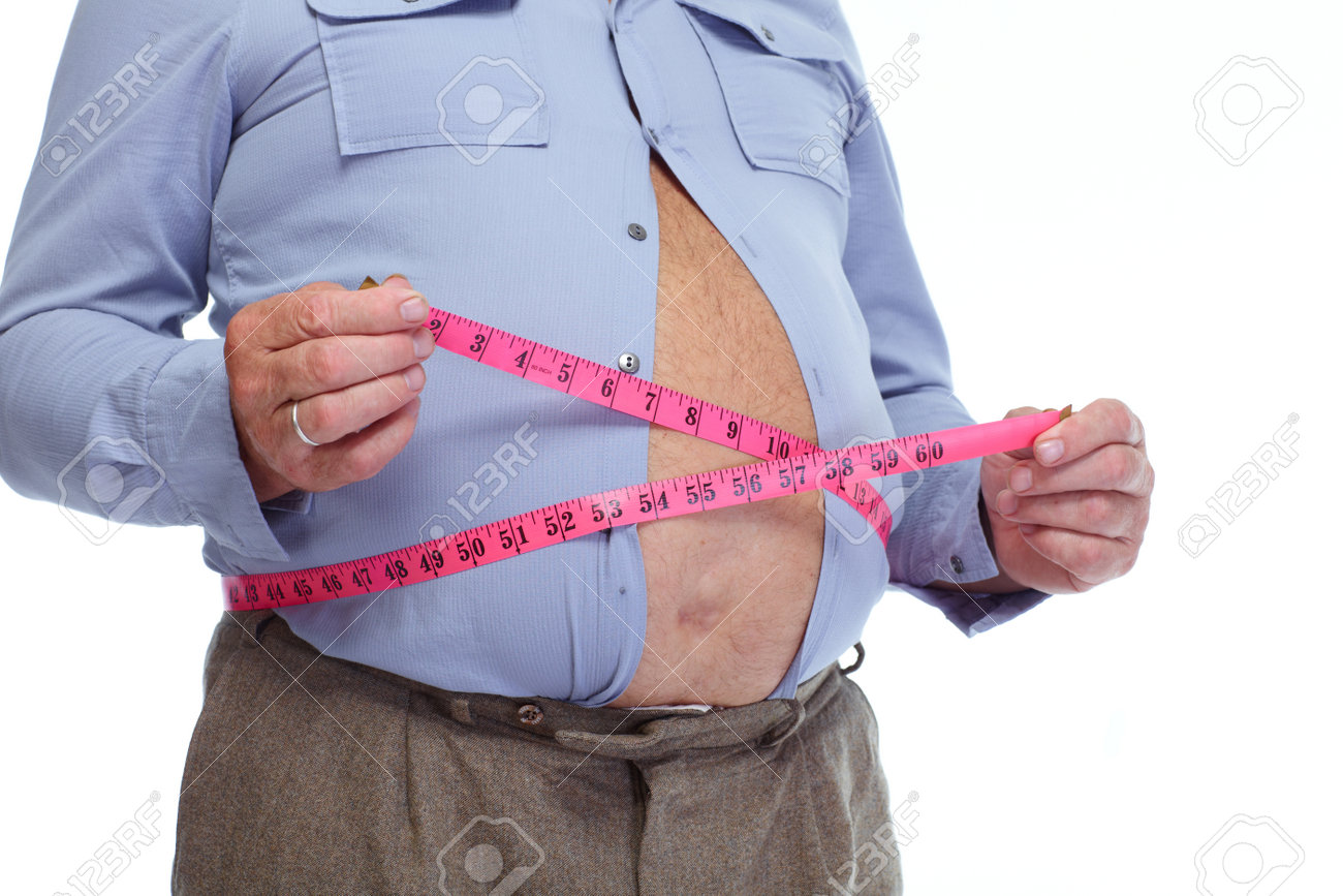 fat man measuring his big stomach weight loss concept measure for weight loss