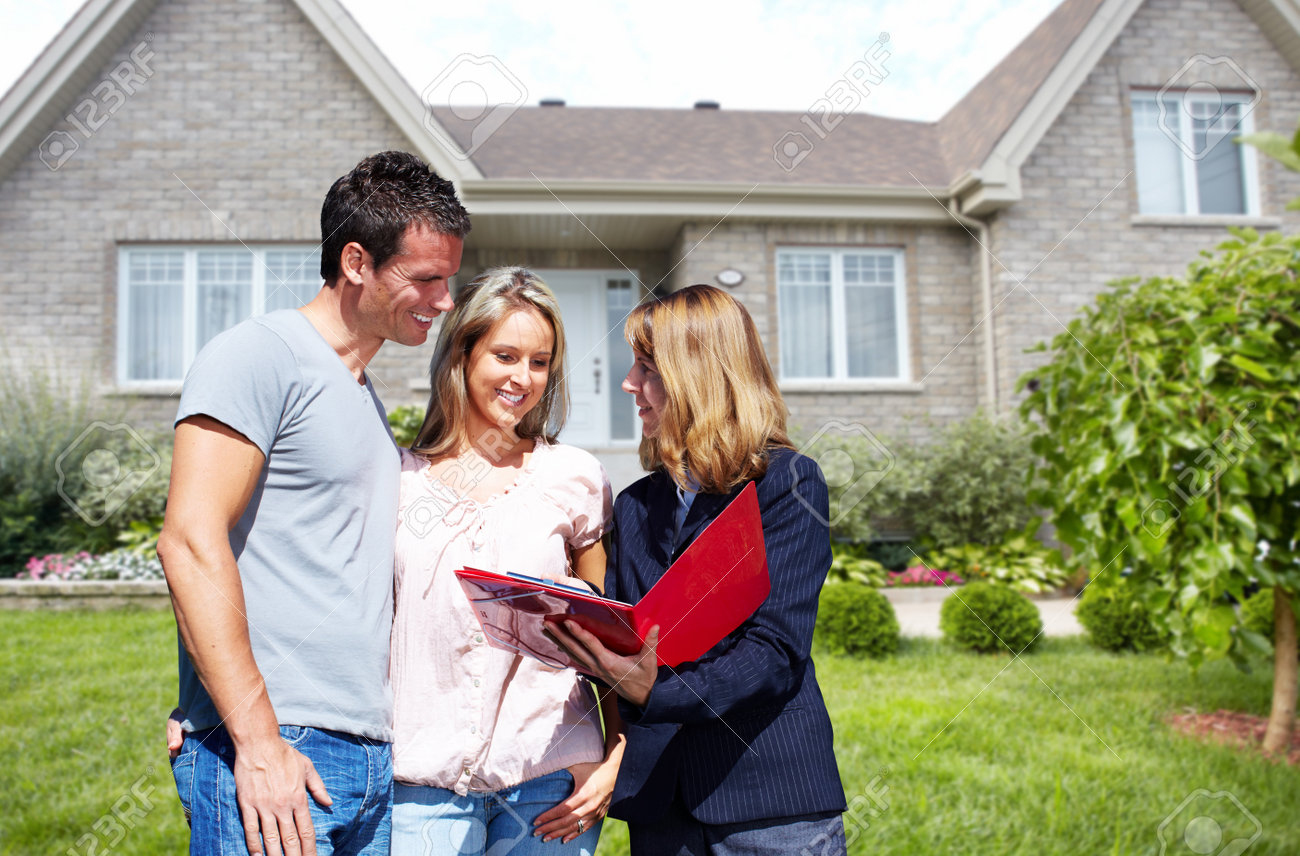 Real Estate agent woman near new house. Home for sale concept. - 57947153 Real Estate agent woman near new house. Home for sale concept. - 57947153