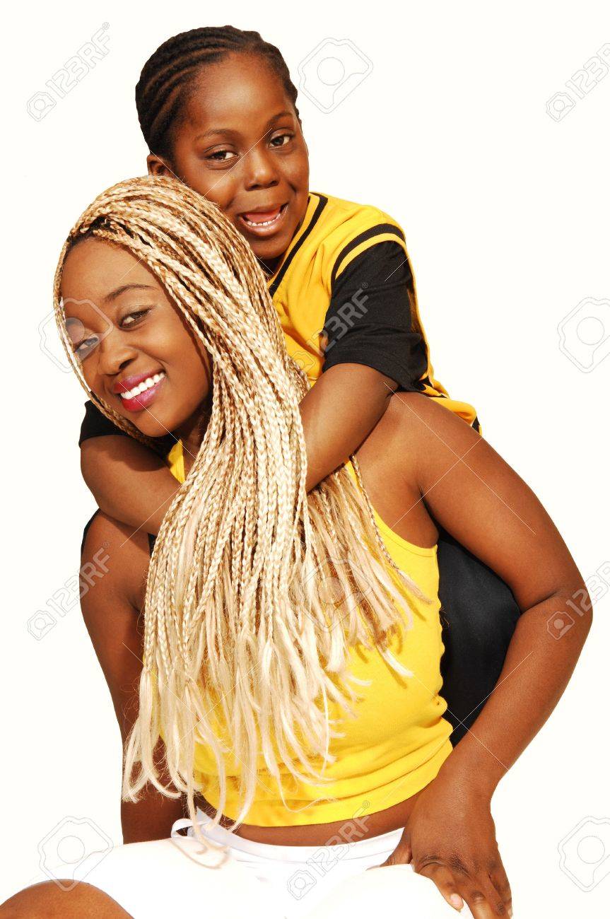 An Older Sister Is Wrestling With Her Younger Brother On The Floor Stock Photo An Older Sister Is Wrestling With Her Younger Brother On The Floor Stock Photo