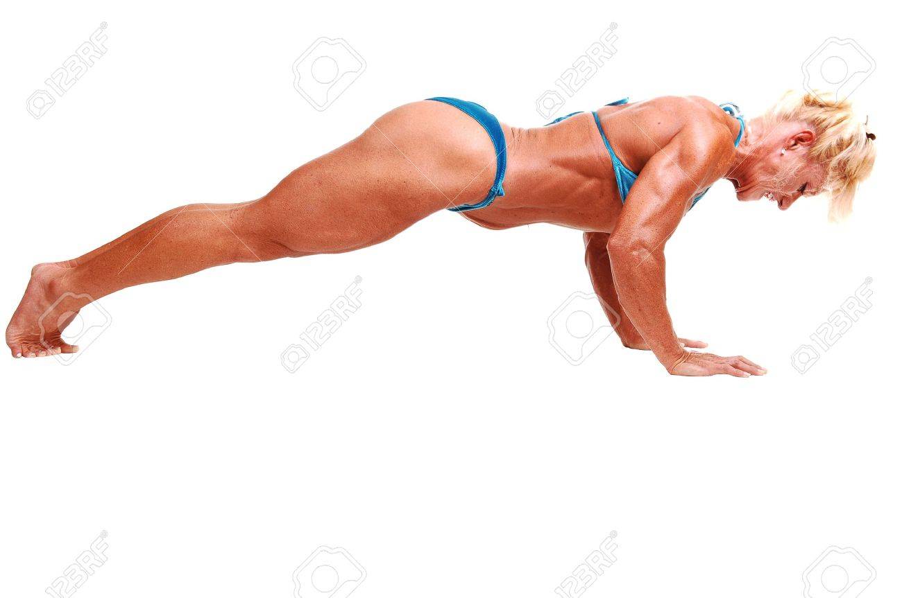 A Blond Muscular Bodybuilding Girl Lying On The Floor In The