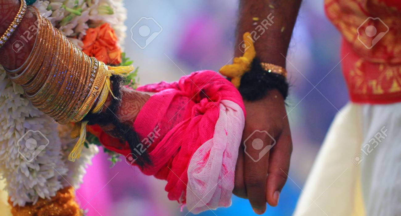 Bride And Groom Hands Together At An Indian Wedding Stock Photo