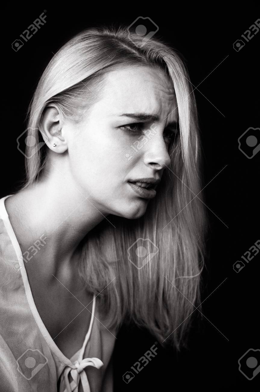 Beautiful girl cries demonstrating her sadness and emotions black and white photo depicting a