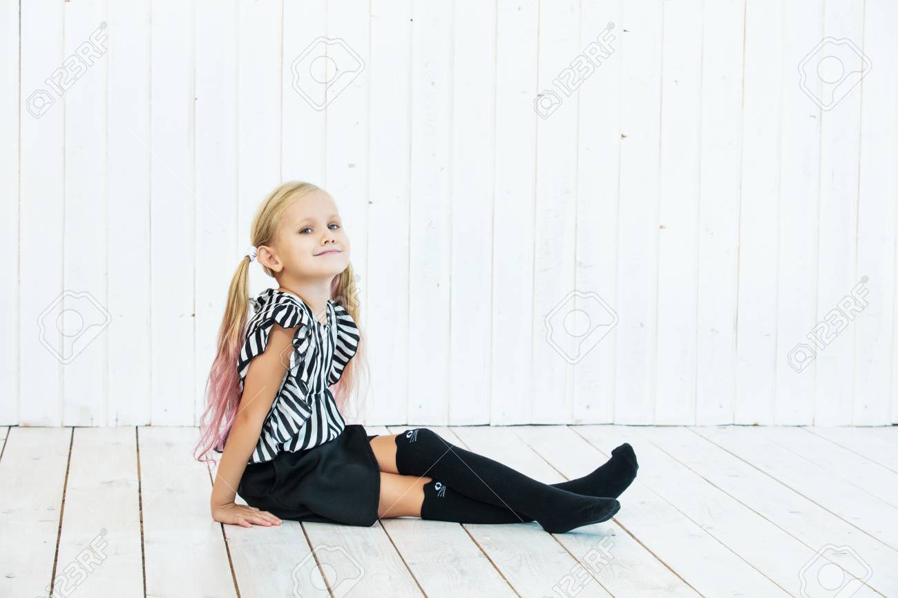 Little beautiful child girl stylish and fashionable on white wooden background - 117673200 Little beautiful child girl stylish and fashionable on white wooden background - 117673200