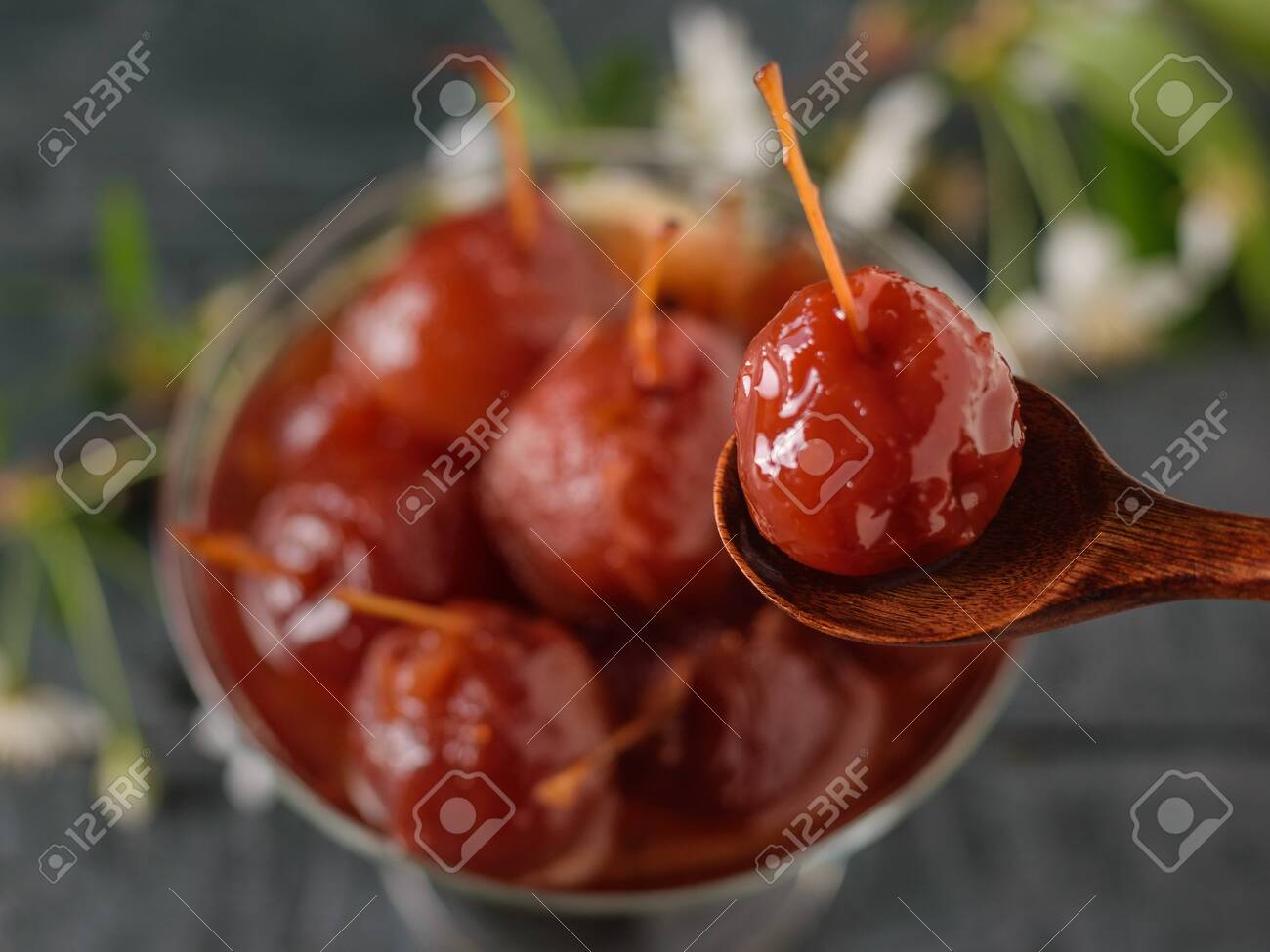 Boiled Apple in a wooden spoon on the background of Apple jam. Homemade sweets according to old recipes. - 122410789 Boiled Apple in a wooden spoon on the background of Apple jam. Homemade sweets according to old recipes. - 122410789