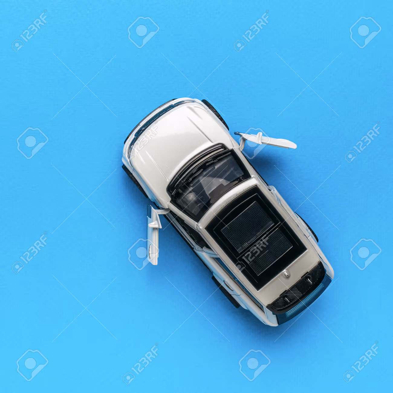 Top view of a white suv with open doors on a blue background the concept of auto mania flat lay - 218063561