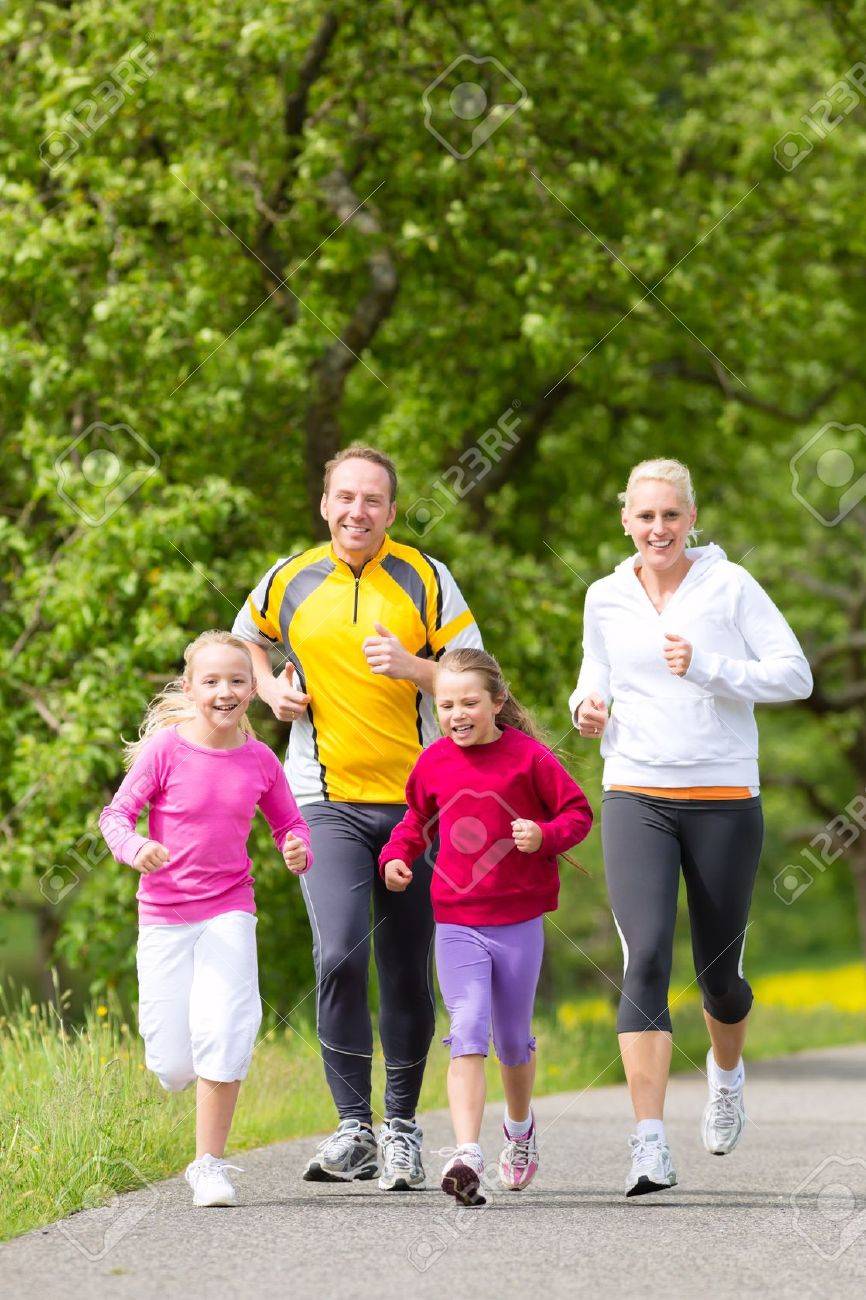 Family Jogging For Sport Outdoors With The Kids On Summer Day ...