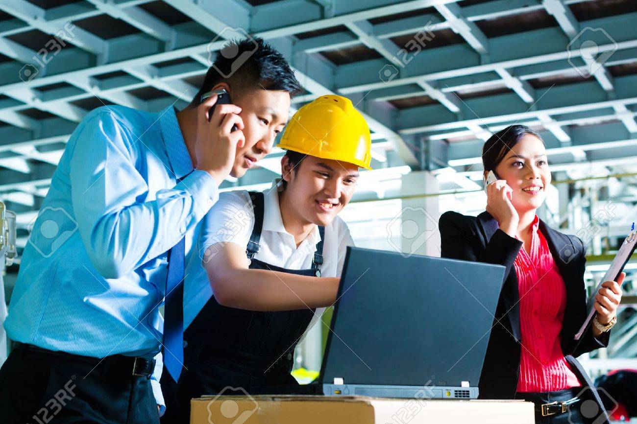 stock photo worker or production manager and customer service look on a laptop in a textile factory and help on the phone - Fashion Production Manager stock photo worker or production manager and customer service look on a laptop in a textile factory and help on the phone - Fashion Production Manager