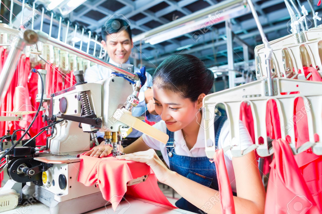 production manager asian seamstress or worker in a textile factory sewing with a industrial sewing - Fashion Production Manager production manager asian seamstress or worker in a textile factory sewing with a industrial sewing - Fashion Production Manager