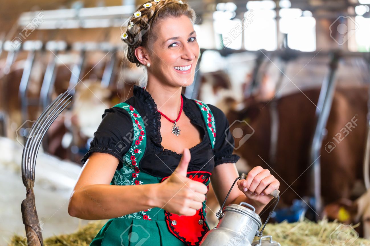 Bavarian Woman With Sexy Dirndl Dress, Milk Can And Pitchfork In Cowhouse  Фотография, картинки, изображения и сток-фотография без роялти. Image  33784166