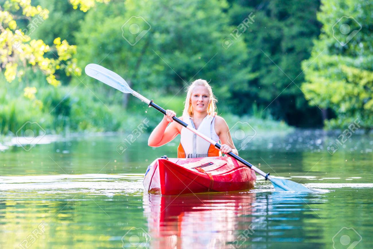 woman driving with kayak on forest river stock photo picture and