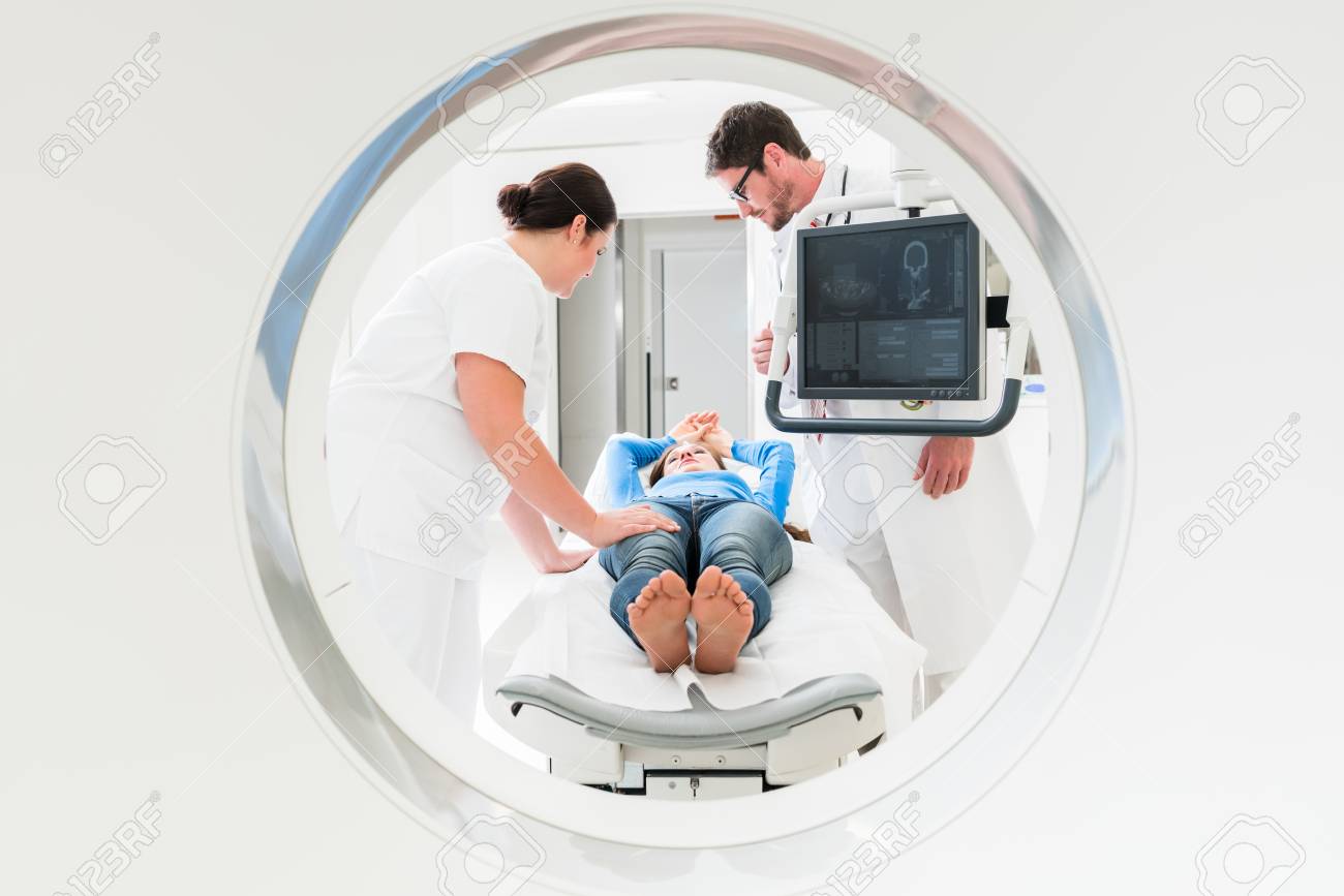 Doctor, nurse, and patient at CT scan tomography in hospital, shot through the tube of device - 96348339 Doctor, nurse, and patient at CT scan tomography in hospital, shot through the tube of device - 96348339