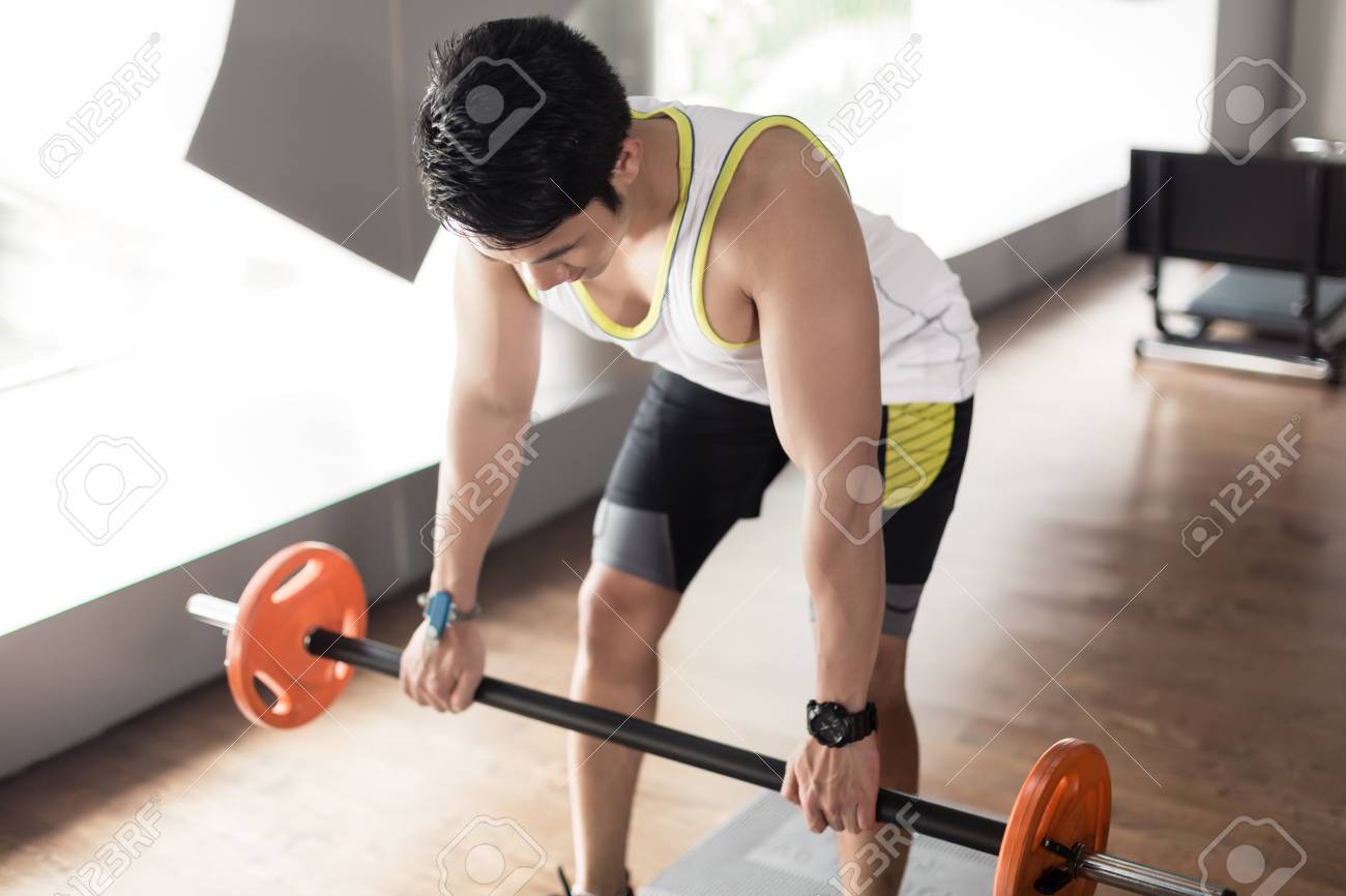 Fit Asian Young Man Exercising Bent Over Rowing With Barbell