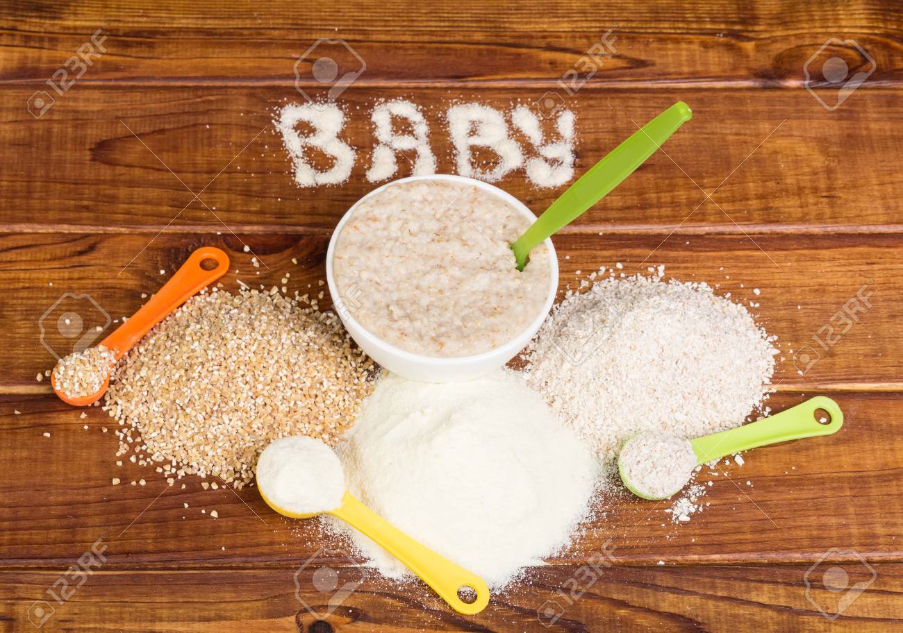 Bowl with oatmeal and a variety of cereals to prepare the porridge on the background of dark wood. - 67390807 Bowl with oatmeal and a variety of cereals to prepare the porridge on the background of dark wood. - 67390807