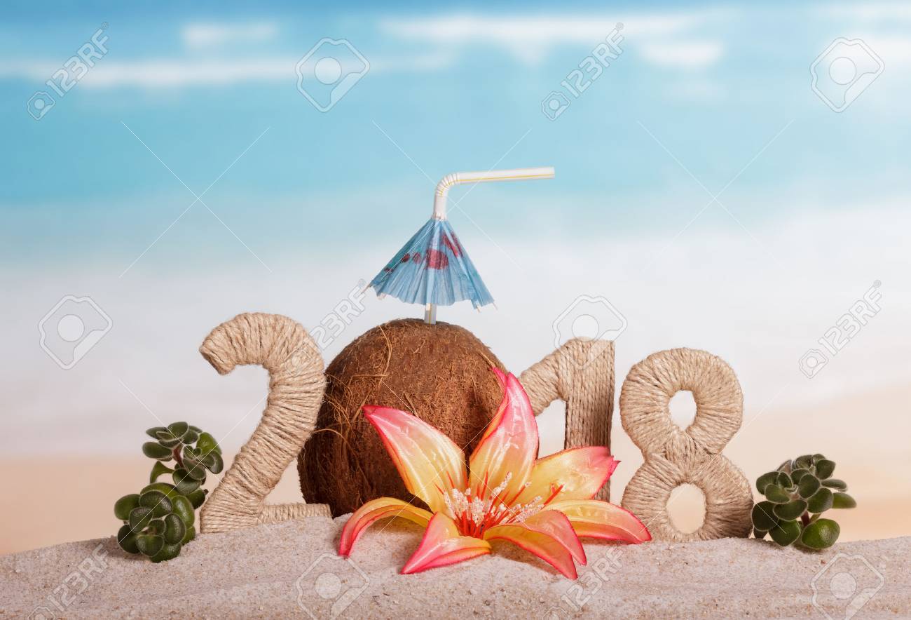 New Year inscription 2018, coconut with drinking straw and umbrella instead of the number 0, flower and green leaves on the sand. - 88003413 New Year inscription 2018, coconut with drinking straw and umbrella instead of the number 0, flower and green leaves on the sand. - 88003413