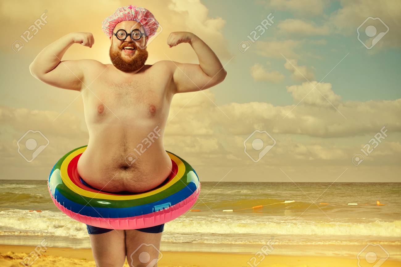 83660457-funny-fat-man-in-a-swimsuit-with-an-inflatable-ring-on-the-beach-in-the-summer-.jpg