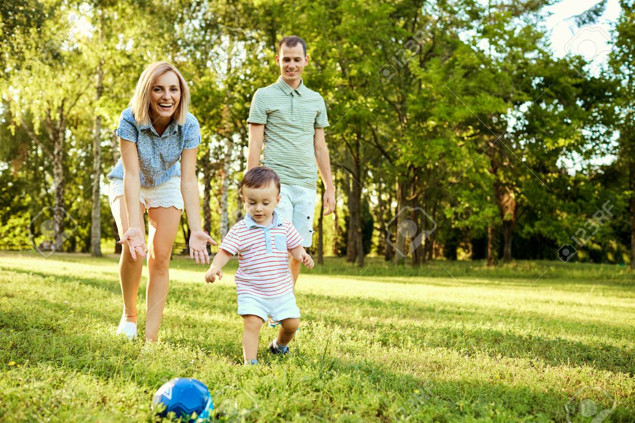 Happy Family In Nature. Parents With A Child Play In Park. Stock Photo,  Picture and Royalty Free Image. Image 95923884.
