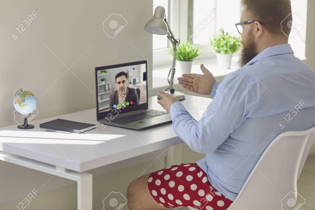 Online Work At Home. Funny Fat Businessman In A Shirt In Red Shorts Works  Communicates Video